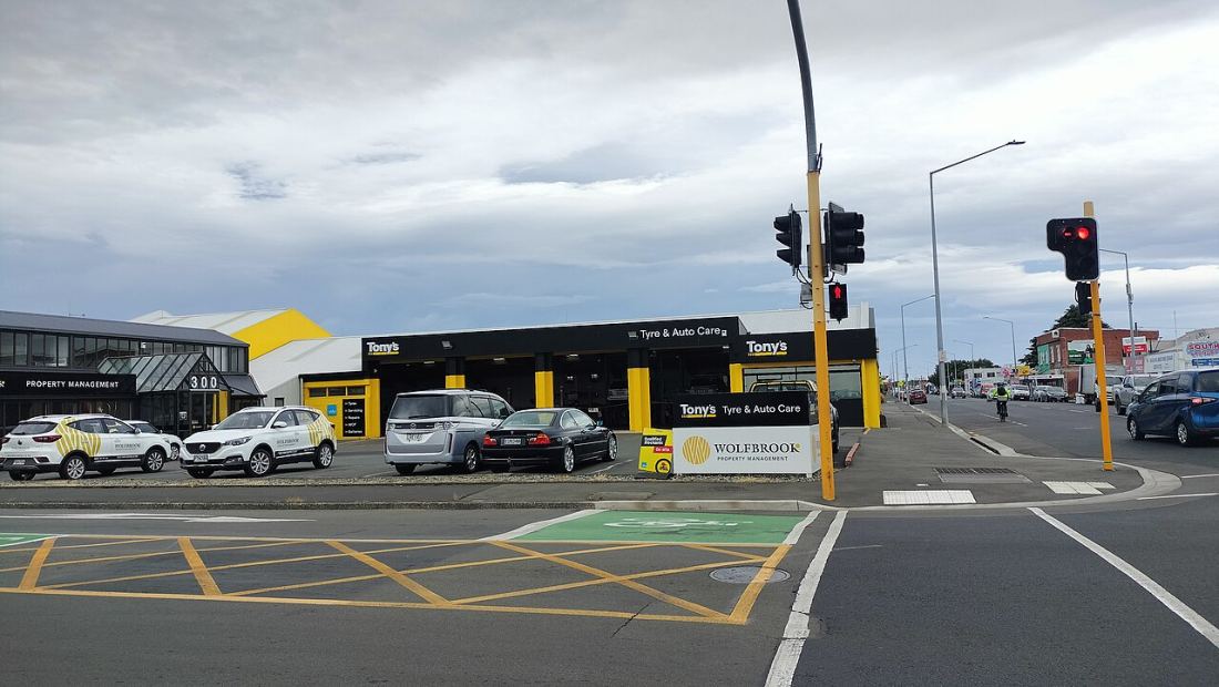 A tyre and auto care shopfront with cars parked outside