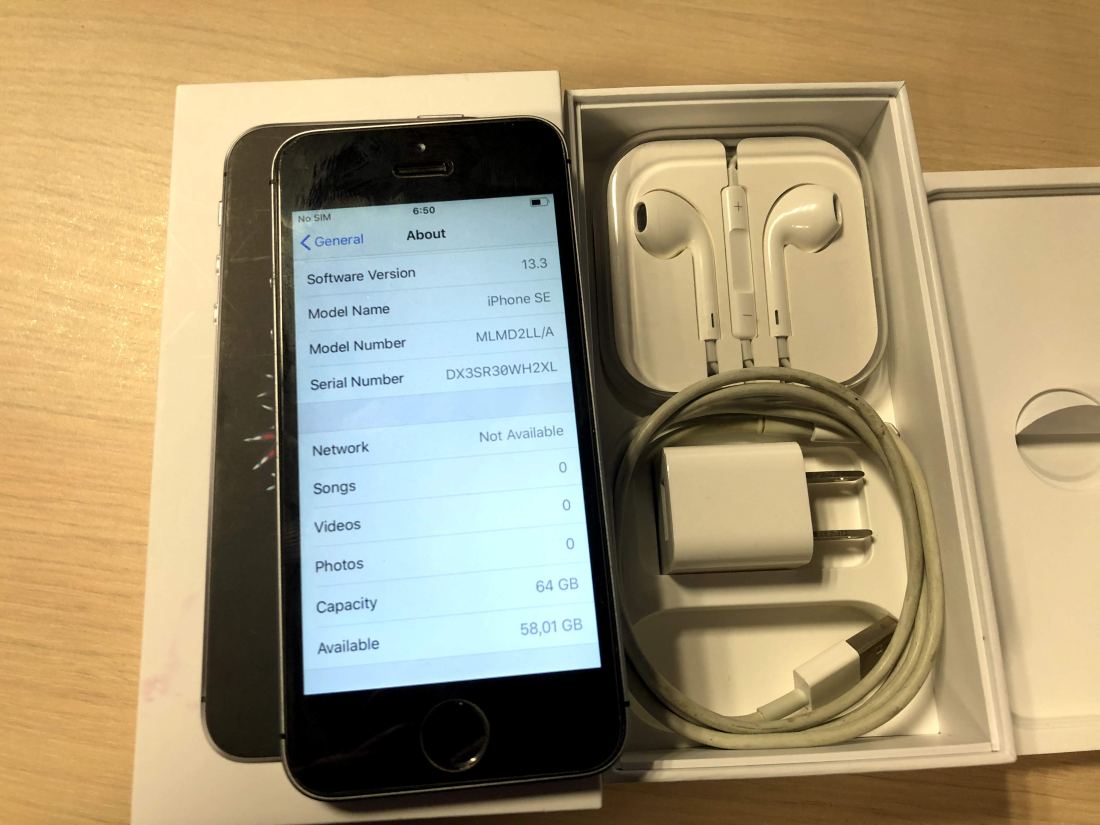 A smartphone with its box and accessories
