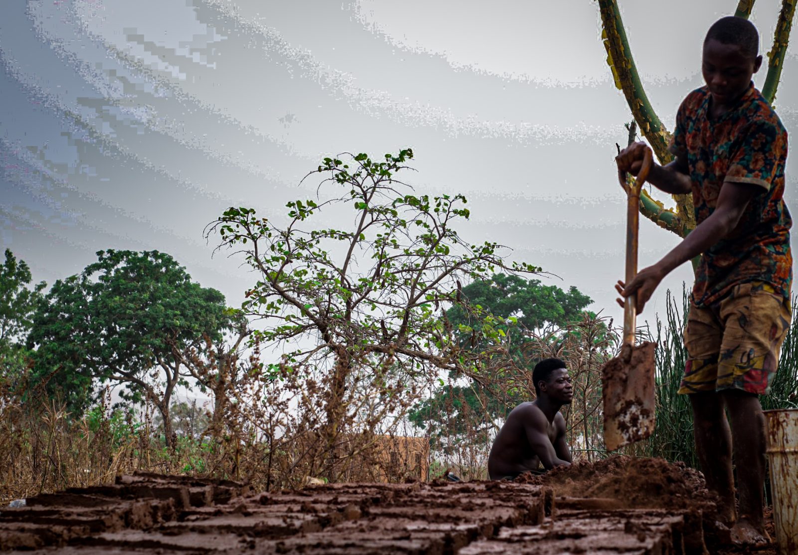 Clay being moulded into bricks by hand