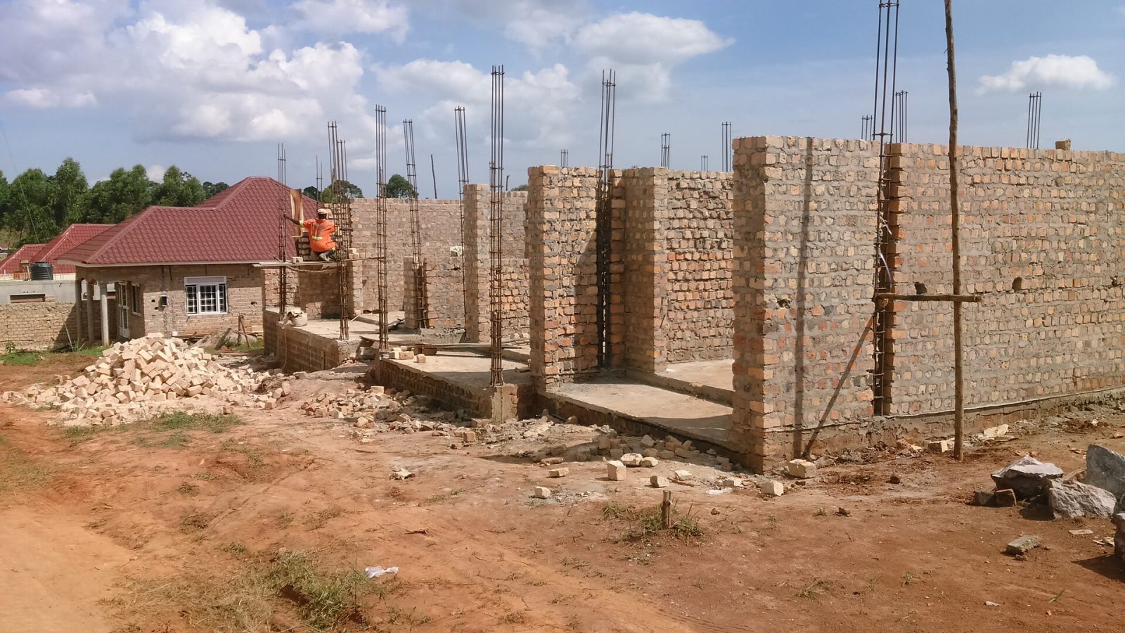 House under construction with brickwork and columns